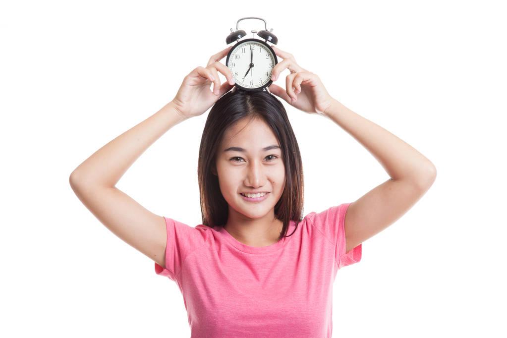 Young Asian woman smile with a clock. - Photo, Image