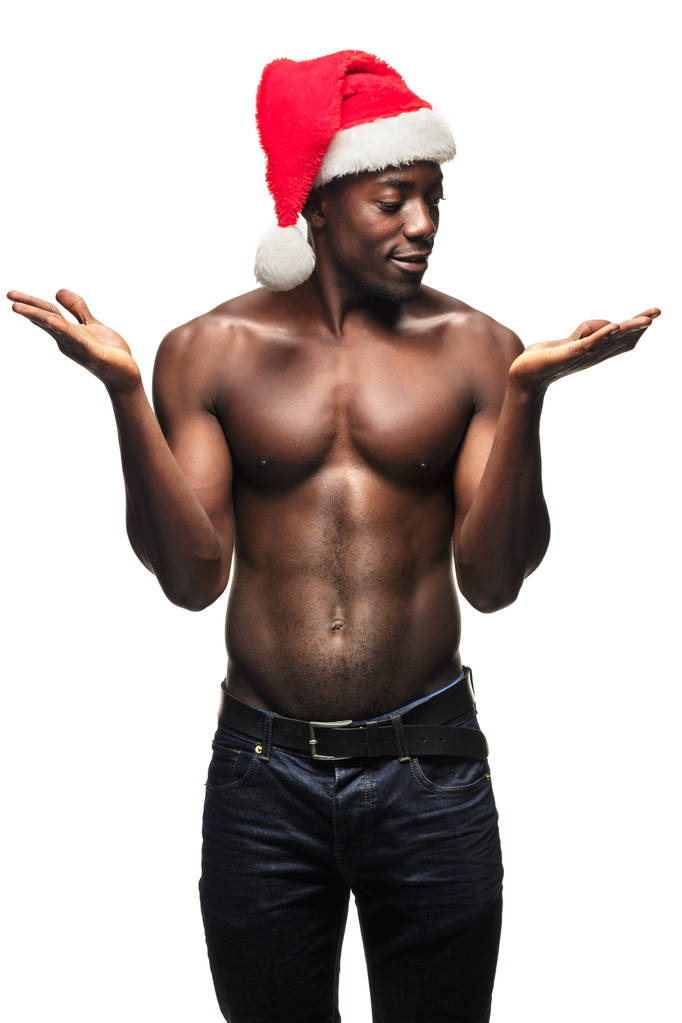筋肉の黒い上半身裸若い男性はサンタ クロースの帽子 - 写真・画像