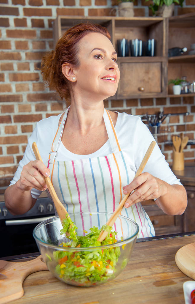 Woman mixing fresh vegetable salad - Photo, Image