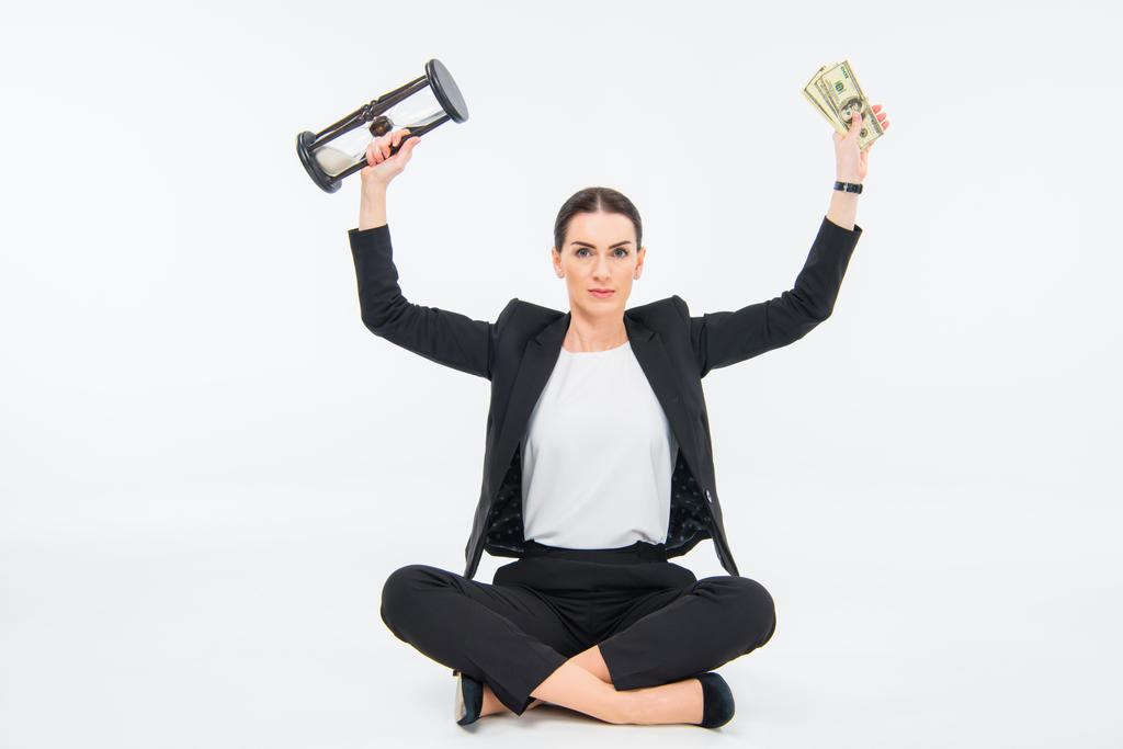 Businesswoman with hourglass and money - Photo, Image