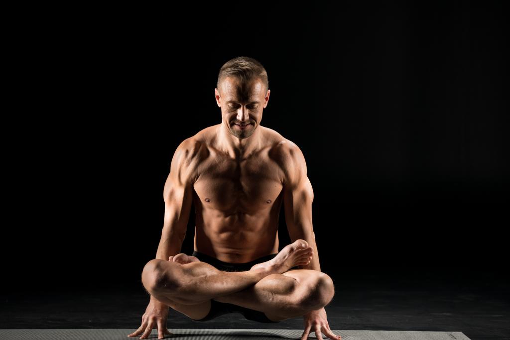 Man sitting in yoga position - Photo, Image