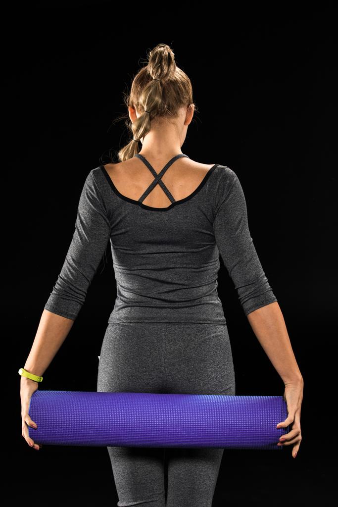 Sportswoman segurando tapete de ioga
  - Foto, Imagem