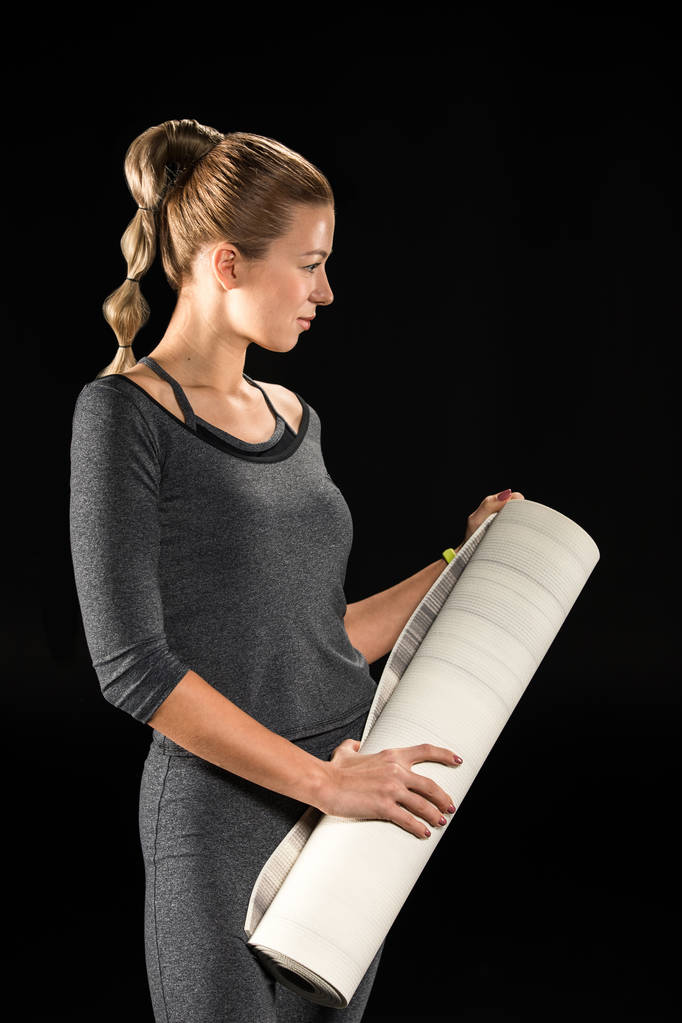 Sportswoman holding yoga mat  - Photo, Image