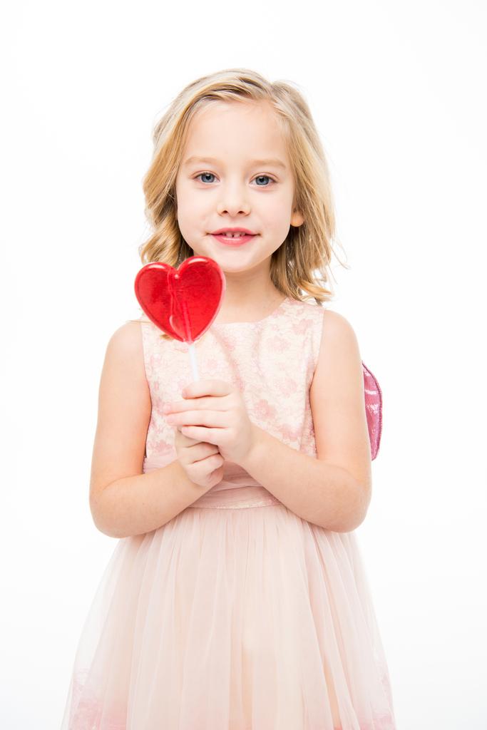 Lány szív alakú nyalókával  - Fotó, kép