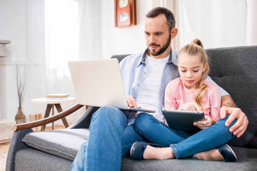 Father and daughter using devices - Photo, Image