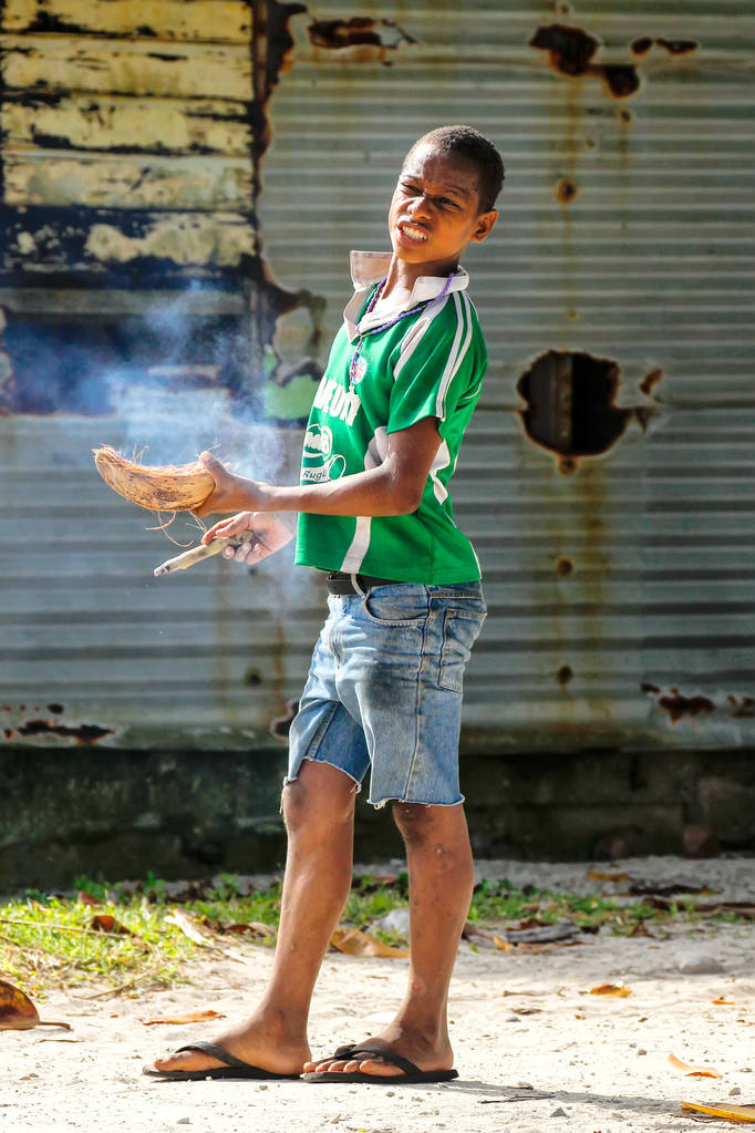 LAVENA, FIJI - NOVEMBER 27: Unidentified boy smokes cigar in Lav - Photo, Image