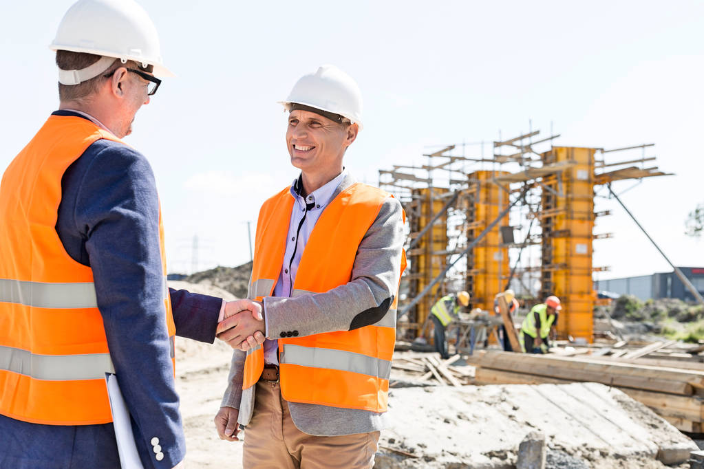 Engineers shaking hands at construction site - Photo, Image