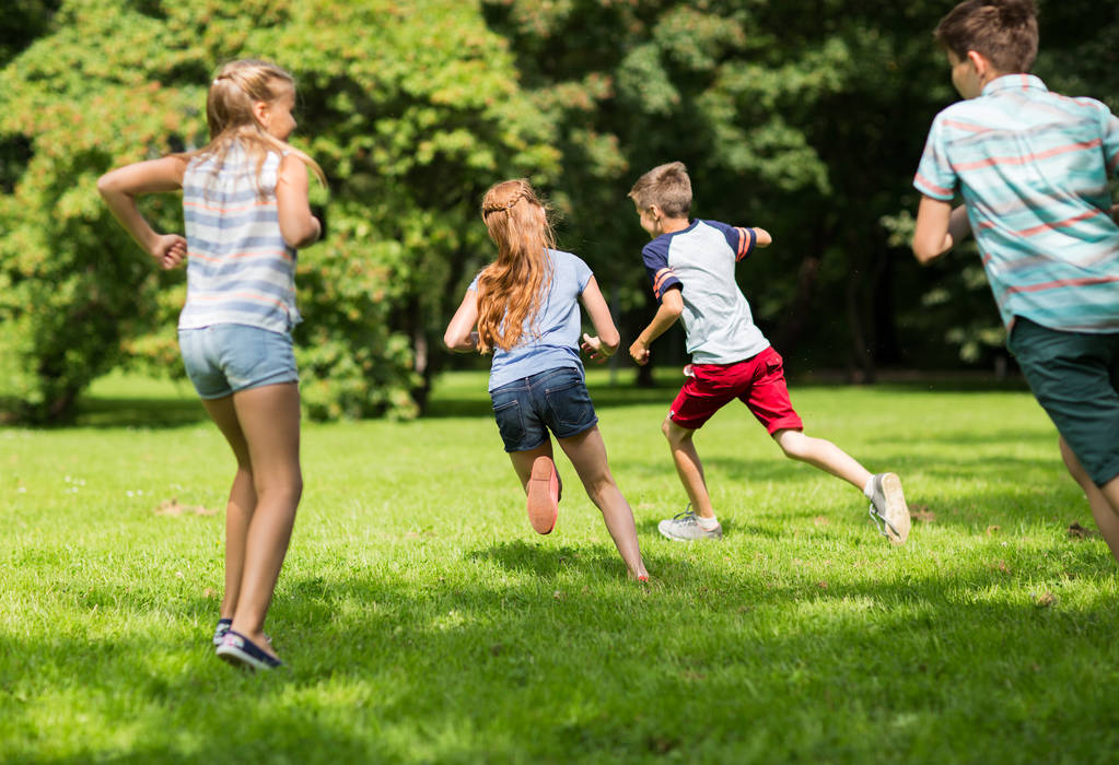 grupo de crianças felizes ou amigos brincando ao ar livre
 - Foto, Imagem