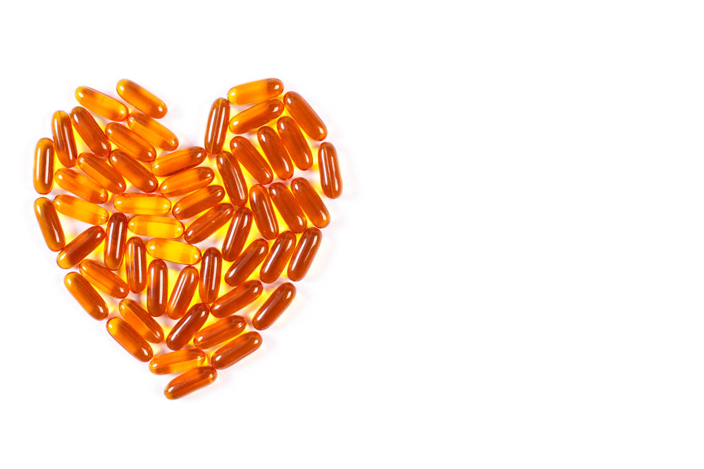 Heart shaped medical pills and capsules on white background, health care concept, copy space for text - Photo, Image