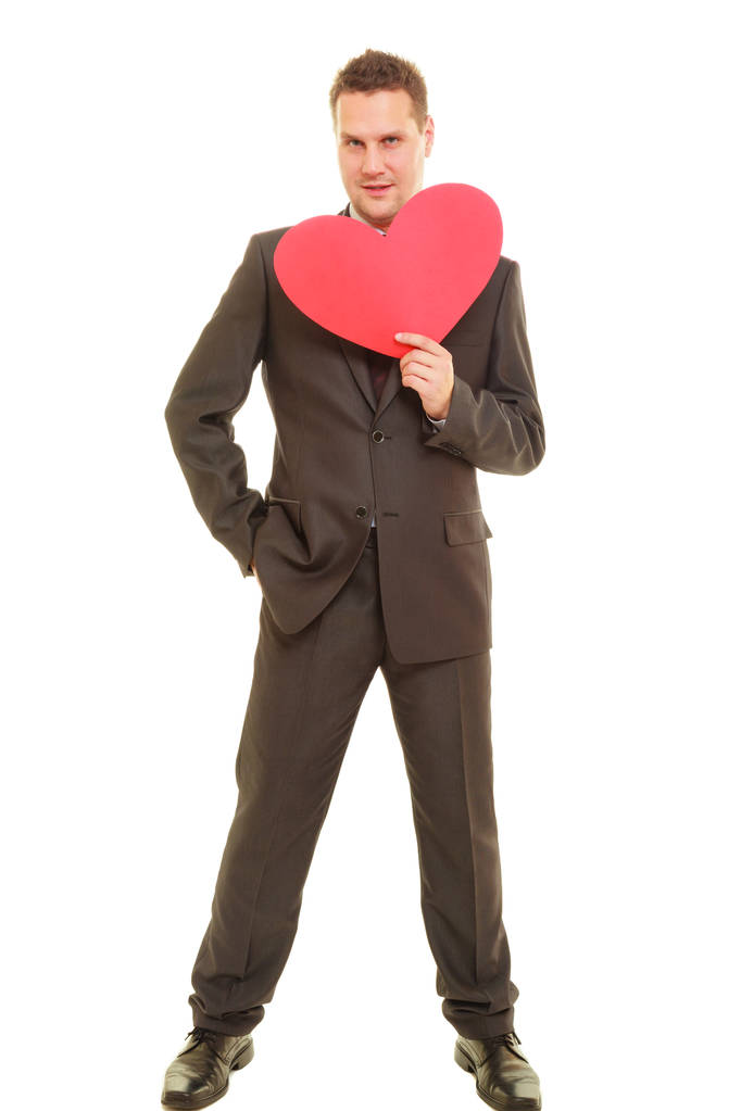 Flirting man in suit holding heart love symbol - Photo, Image