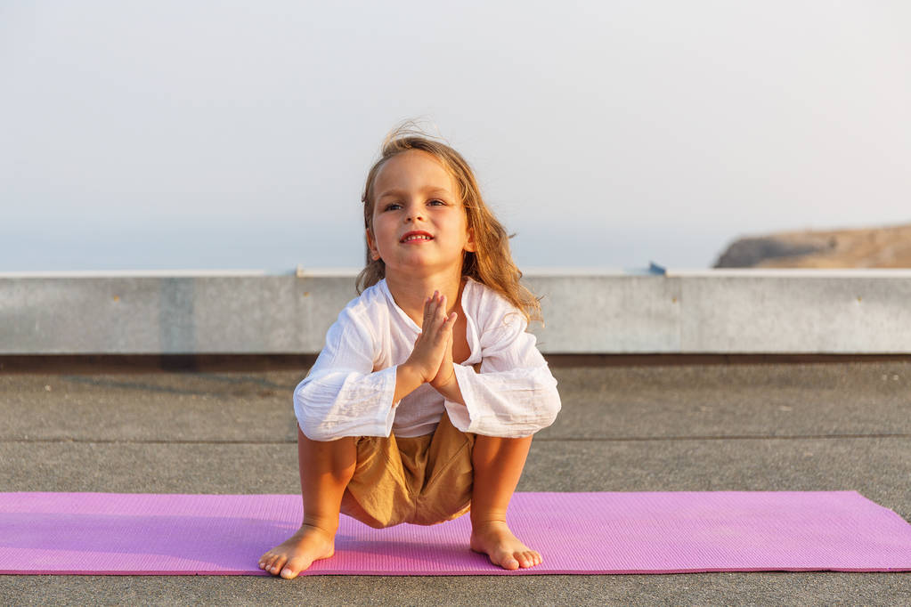 Baby doing yoga on the roof - Photo, Image