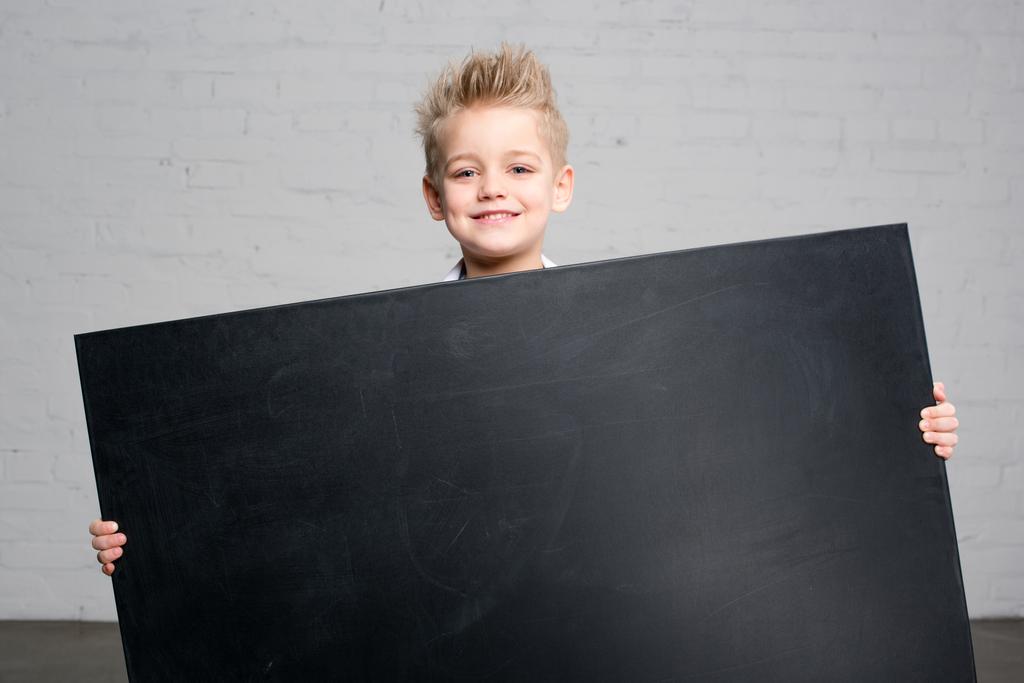 Boy holding blackboard - Photo, Image