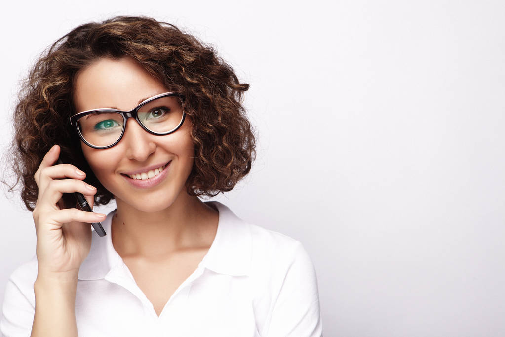 sonriente mujer de negocios teléfono hablando, aislado en el fondo gris
 - Foto, imagen