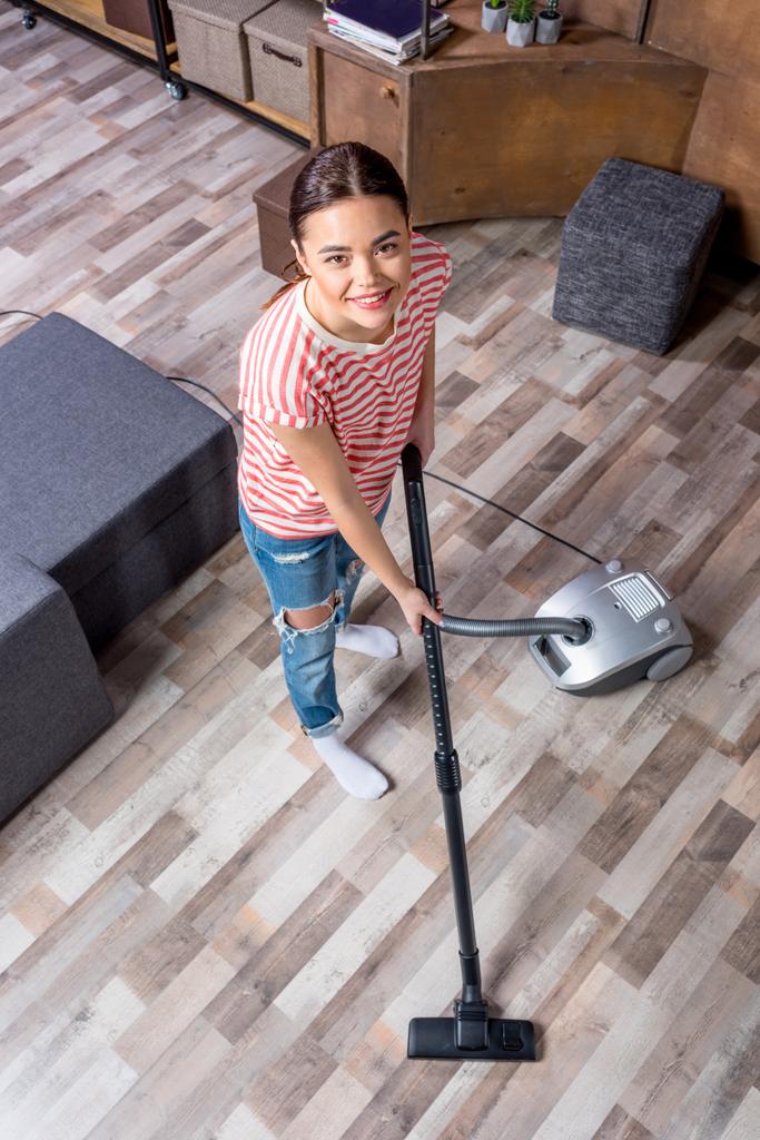 Woman with vacuum cleaner - Photo, Image