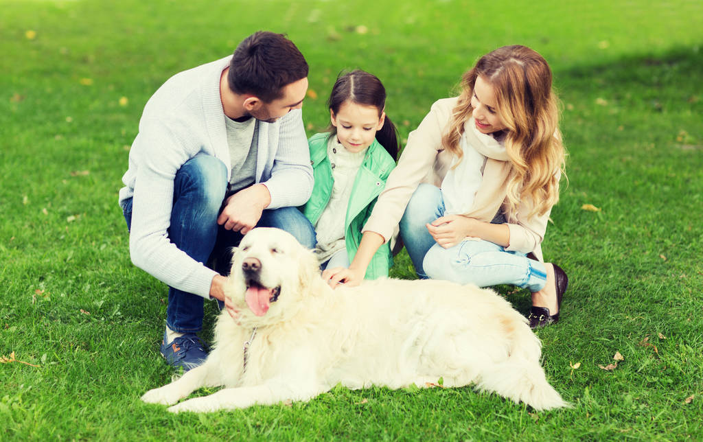 happy family with labrador retriever dog in park - Photo, Image