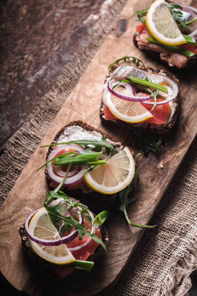 Sandwiches with salmon, herring, lemon on the Danish diagonal - Photo, Image