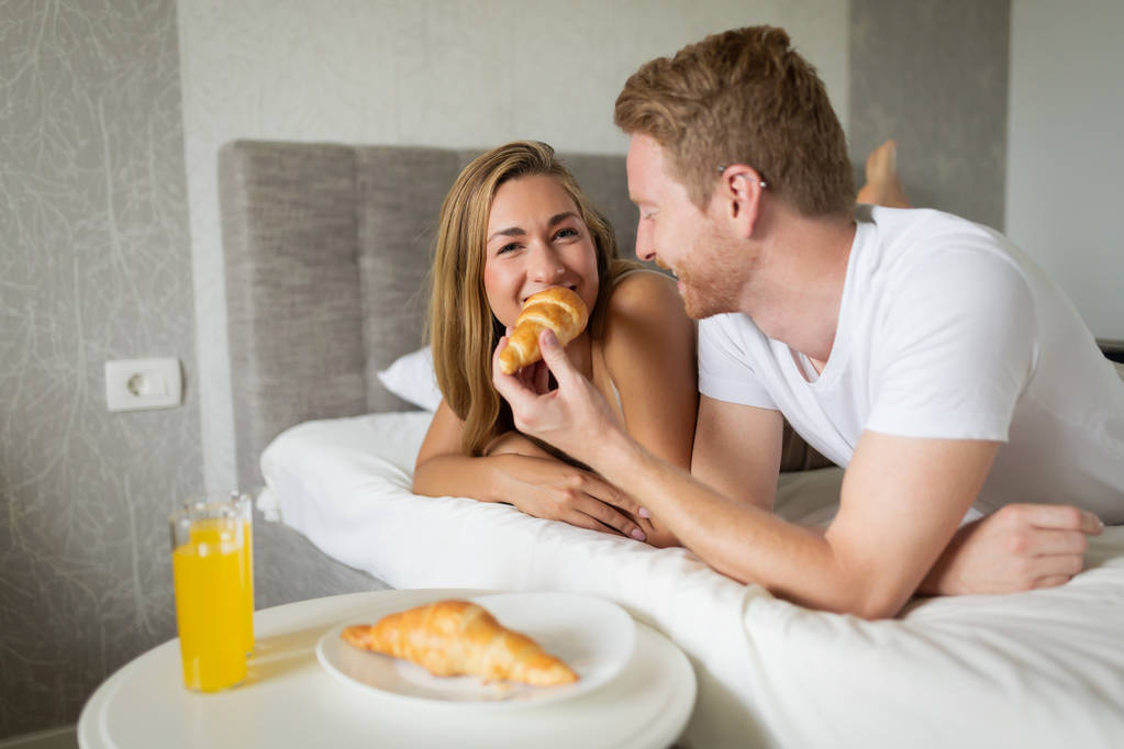 ζευγάρι απολαμβάνει πρωινό στο κρεβάτι - Φωτογραφία, εικόνα