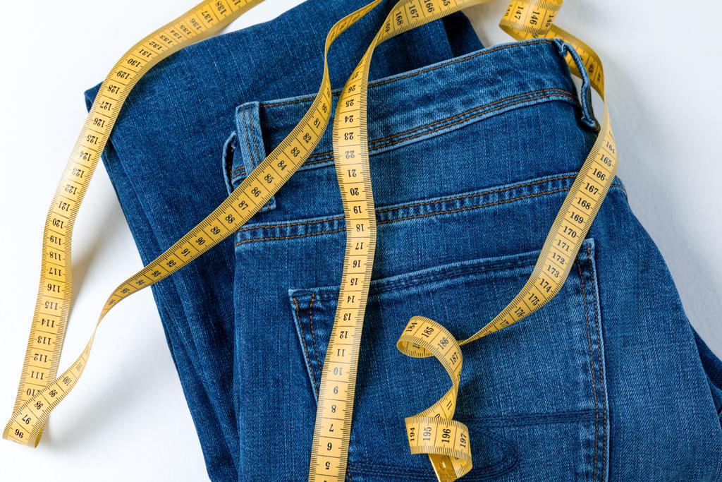 Jeans and measuring tape - Photo, Image