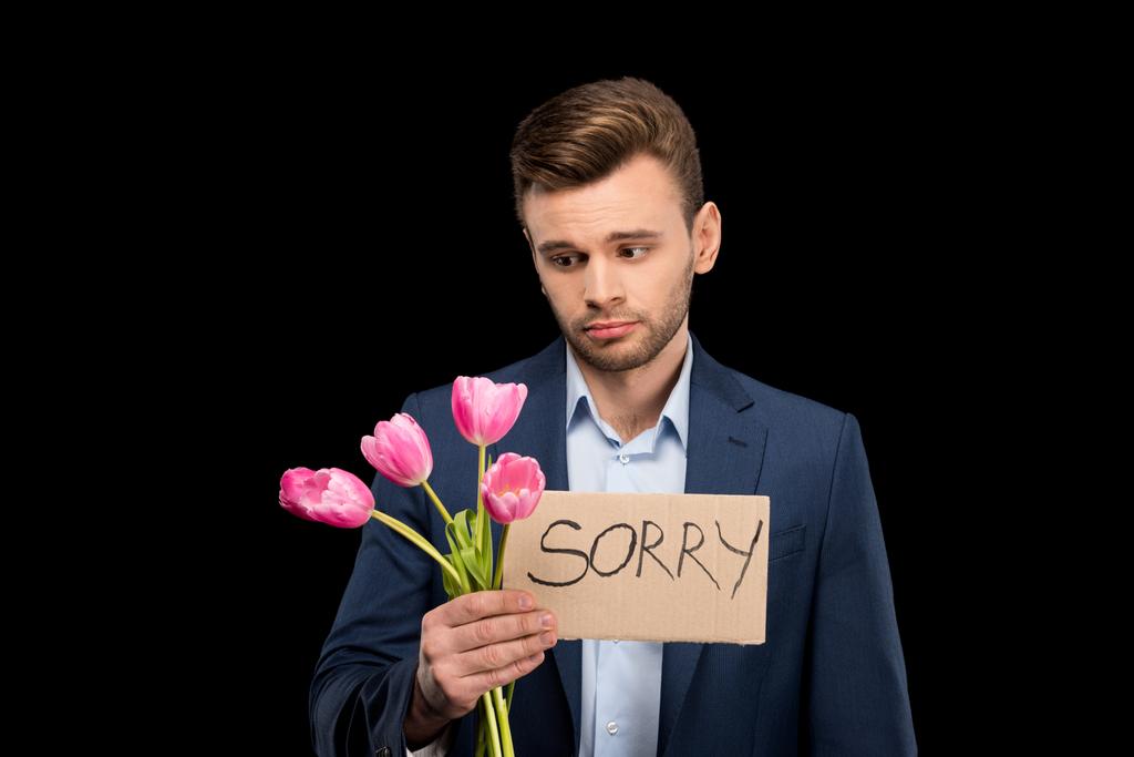 Hombre con tulipanes y señal triste
 - Foto, Imagen