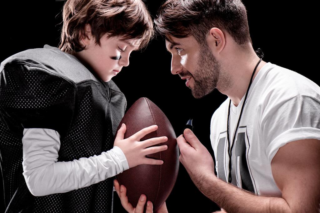 Boy playing football with trainer - Photo, Image