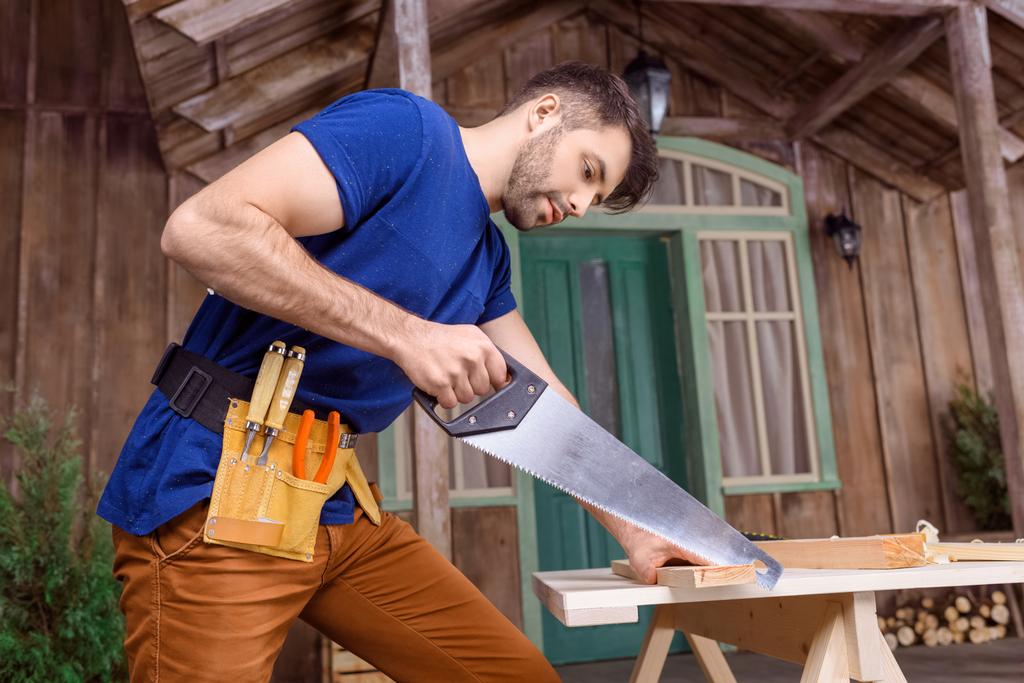carpenter sawing wood - Photo, Image