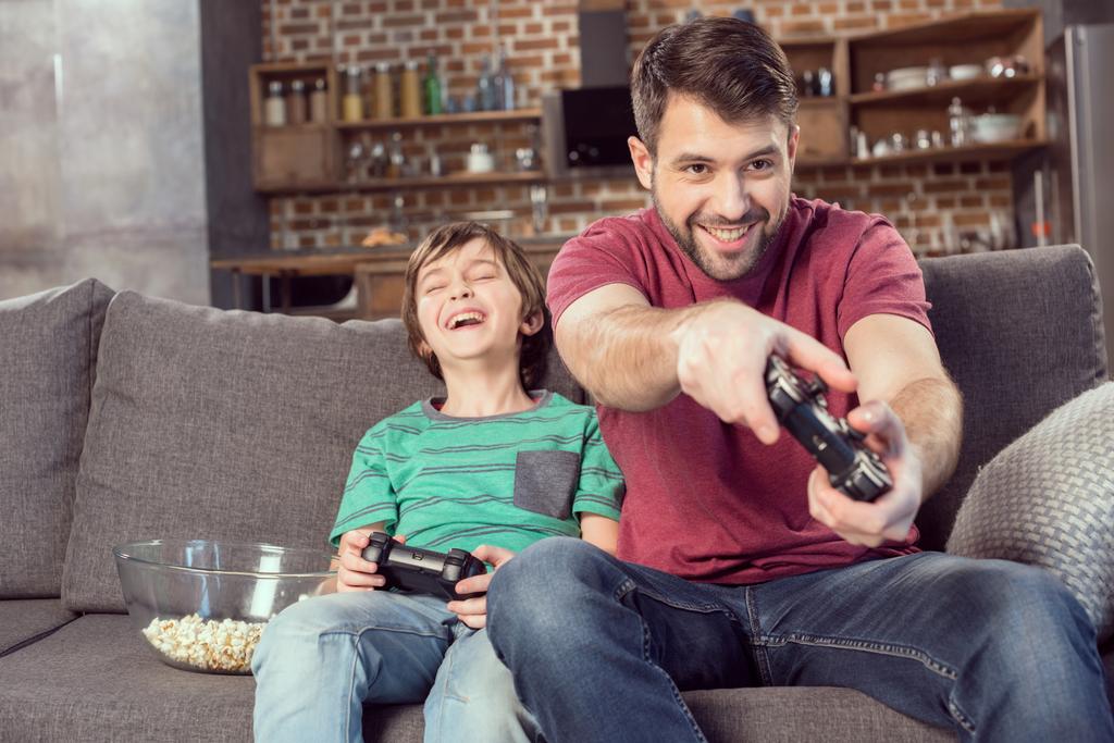 father and son playing video game - Photo, Image