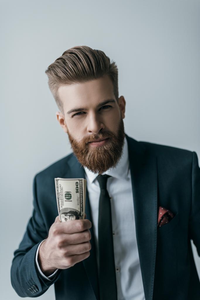 Liikemies, jolla on dollarin seteleitä
 - Valokuva, kuva