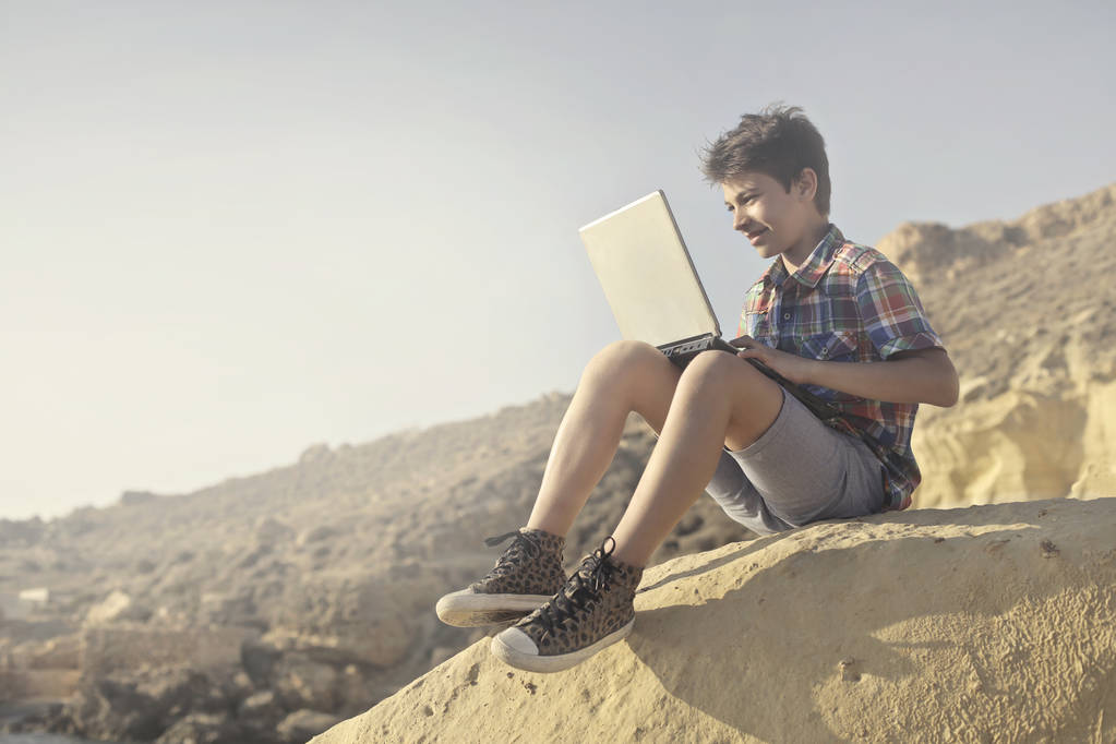 Boy with laptop outdoors - Photo, Image