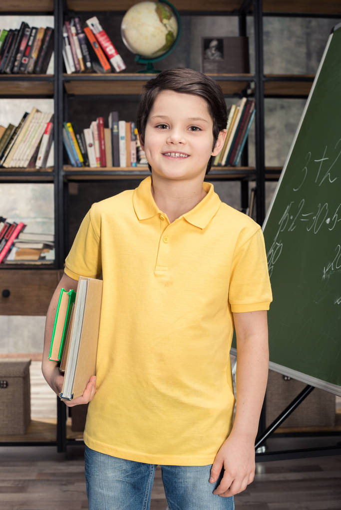 Schoolboy holding books - Photo, Image
