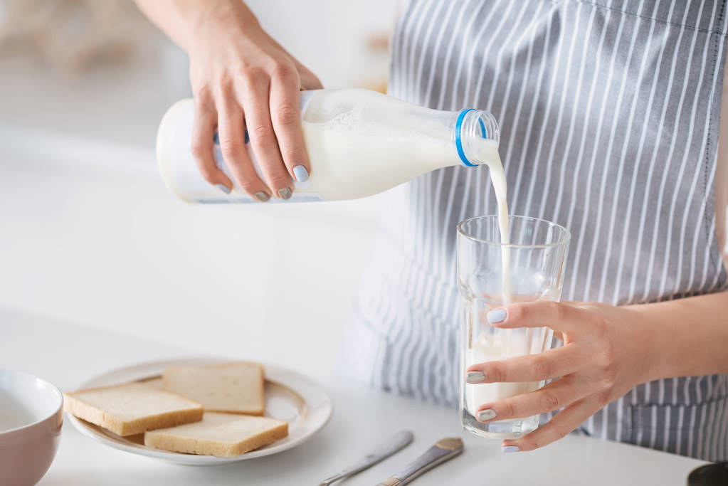 Аккуратная внимательная женщина, кормящая молоко
 - Фото, изображение
