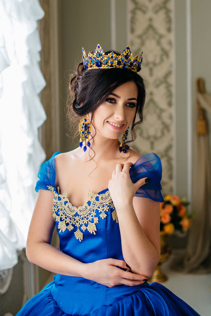 Młoda kobieta w luksusowe niebieską sukienkę i korony - Zdjęcie, obraz