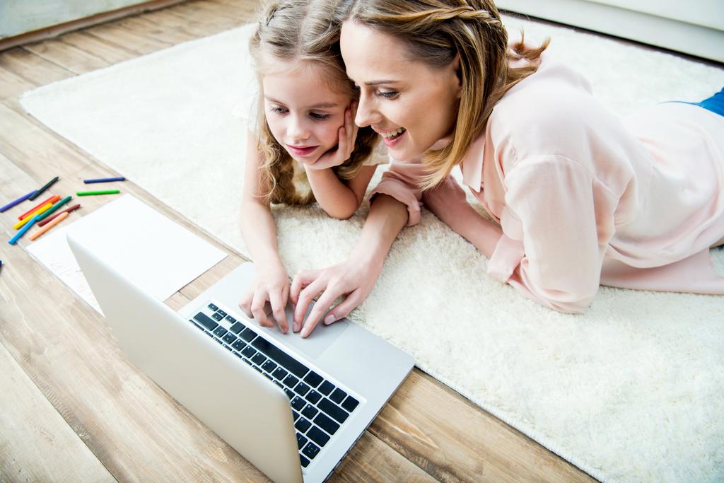 mother and daughter using laptop - Photo, Image
