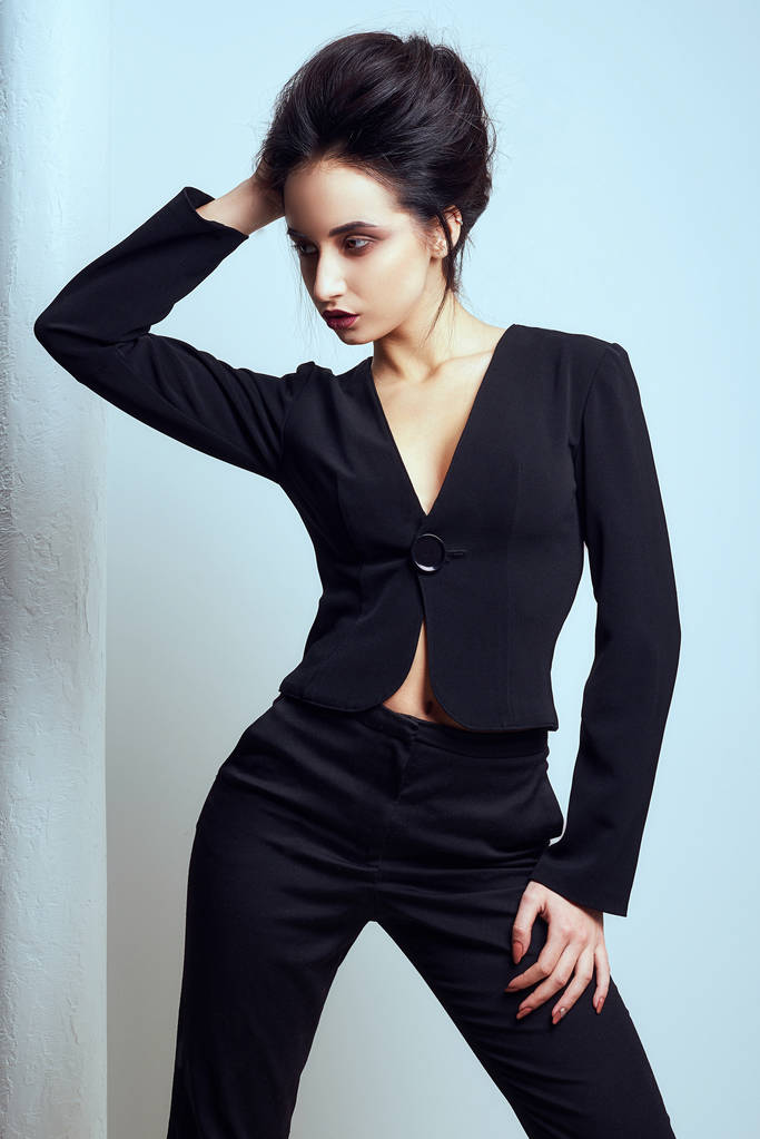 Sexy slim brunette woman posing in studio wearing fashionable jacket - Photo, Image