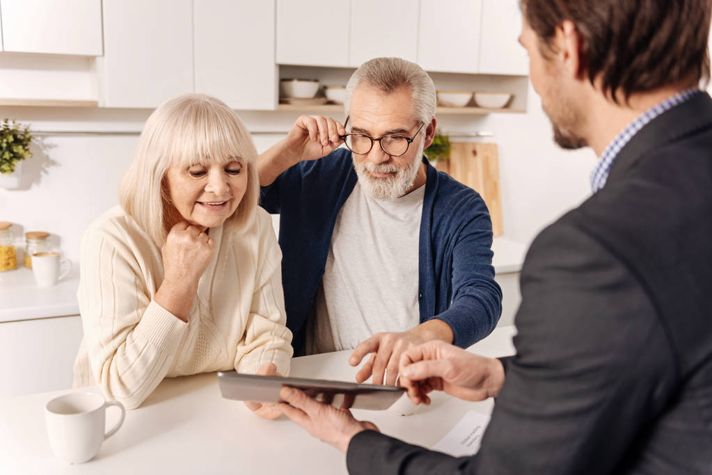 couple using gadget with real estate agent - Photo, Image