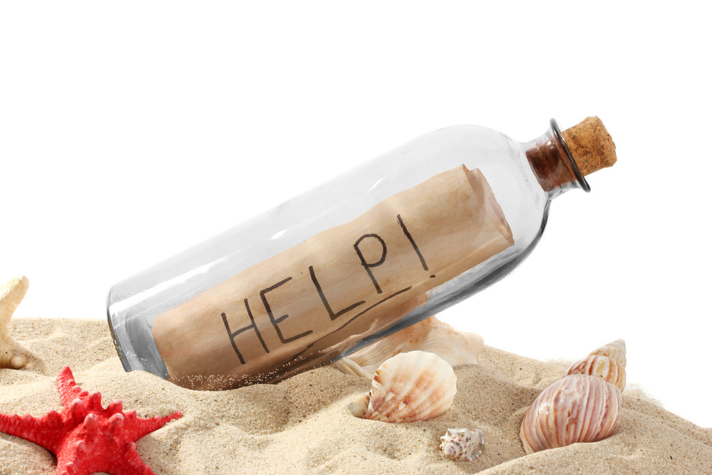 Glass bottle with note inside on sand isolated on white - Photo, Image