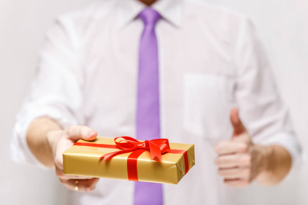Male hands holding a gift box with ribbon. - Photo, Image