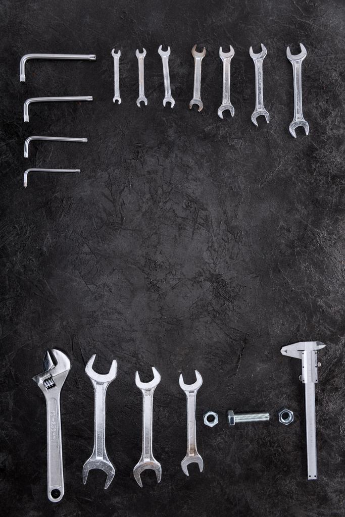 Top view of set of construction tools, wrenches and spanners on black - Photo, Image