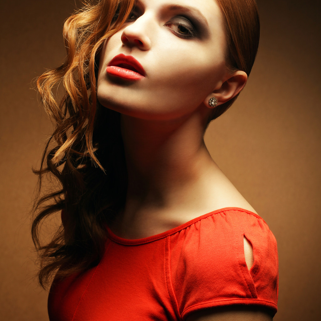 Portrait of an inaccessible beautiful ginger girl in orange dres - Photo, Image