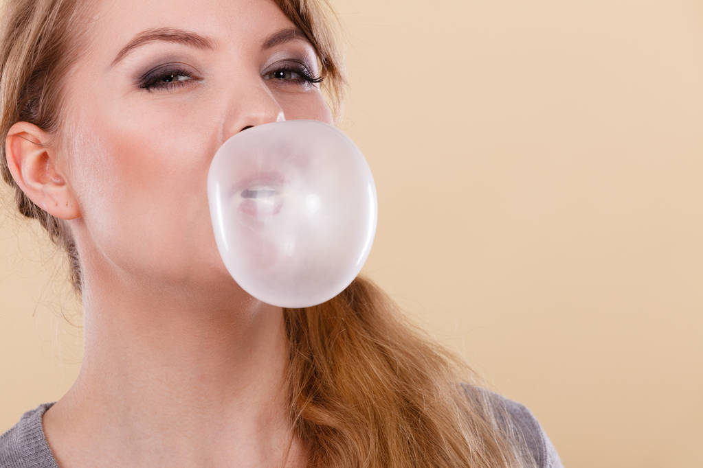 Blond meisje kauwgom maken ballon. - Foto, afbeelding