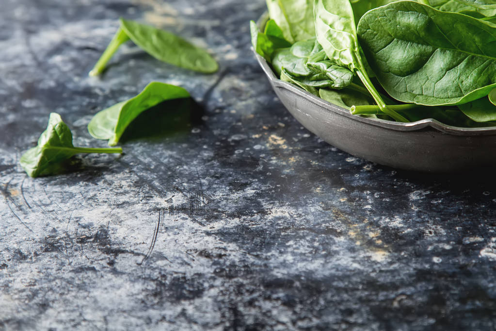 Washed fresh mini spinach on the old concrete table - Photo, Image