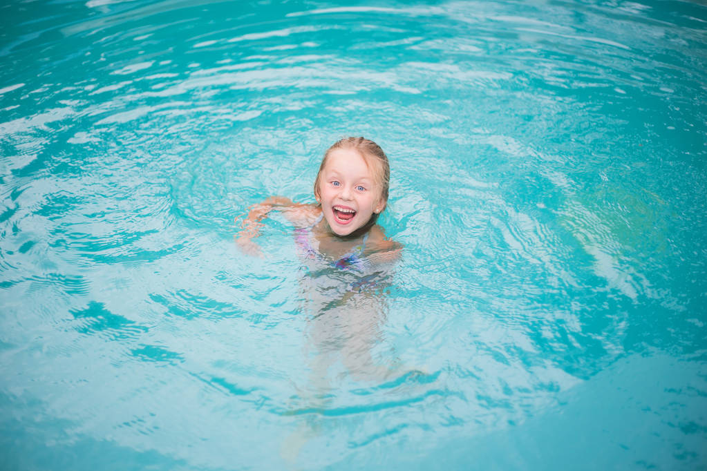 Muotokuva söpö onnellinen pieni tyttö hauskaa uima-altaassa
, - Valokuva, kuva