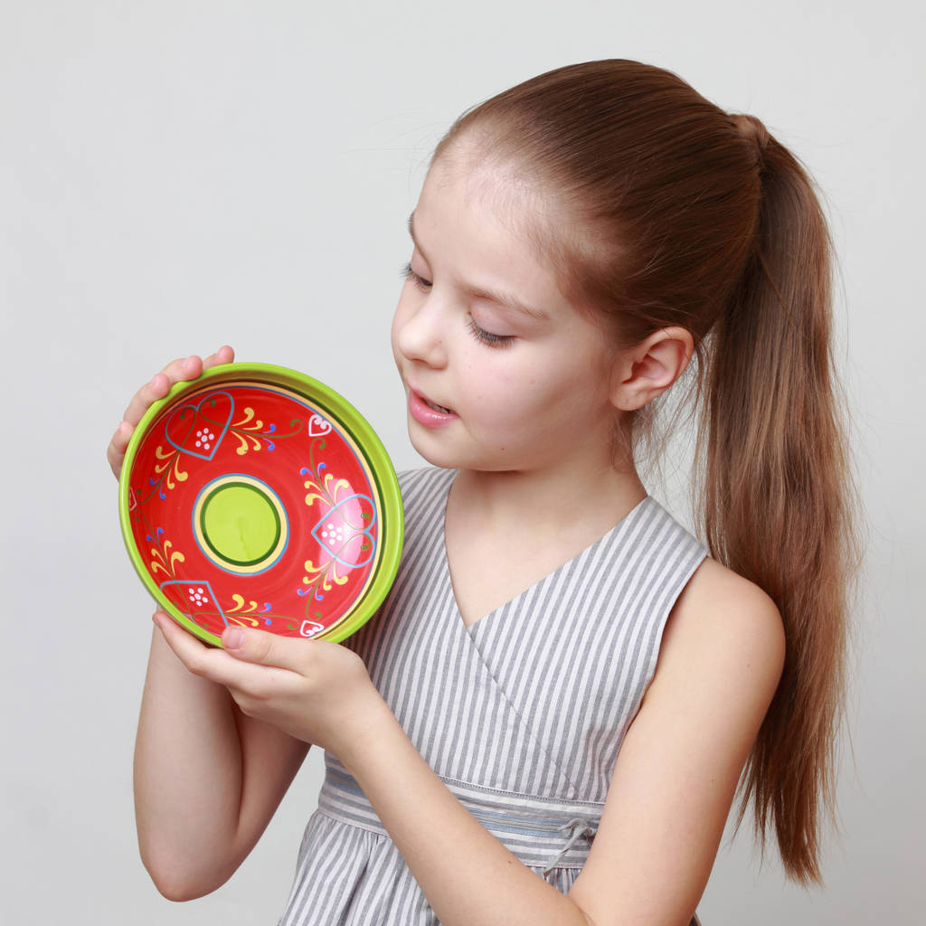 Emotional little girl holding colorful ceramic bowl - Photo, Image