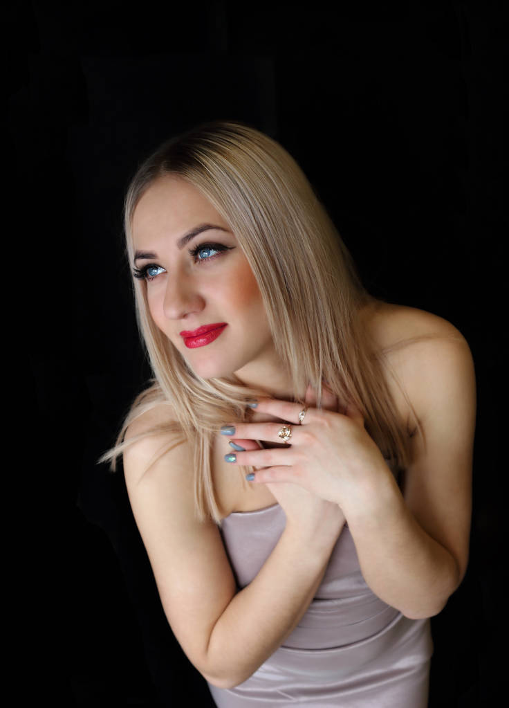 blond woman in dress on black background - Photo, Image