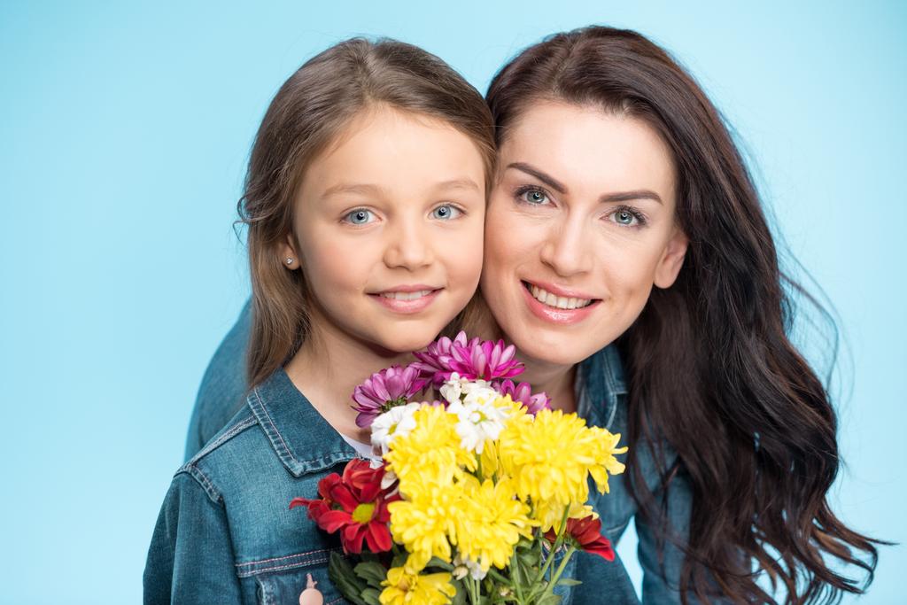 mother and daughter holding flowers - Photo, Image
