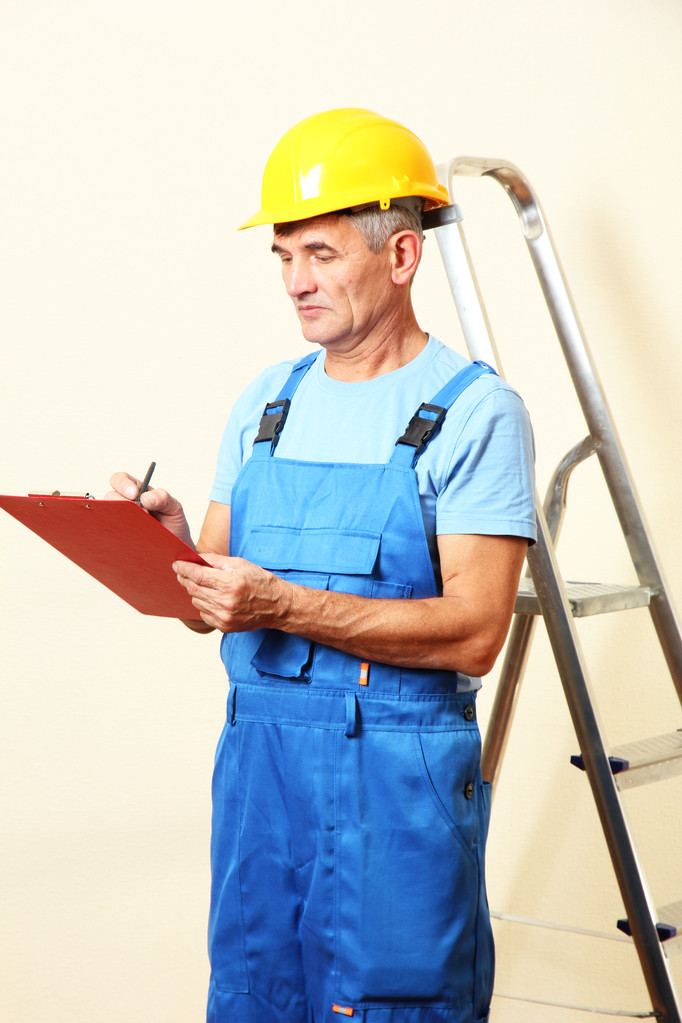 Builder enters into contract on work on wall background - Photo, Image