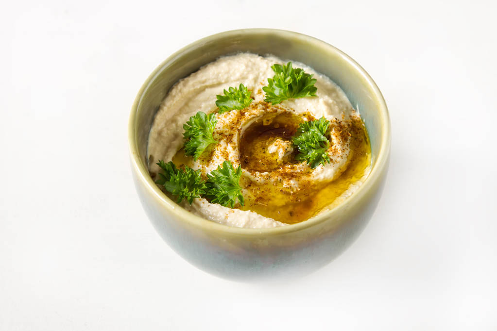 Vegetarian snack. Hummus with greens, dressed with olive oil and - Photo, Image