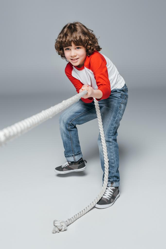 Cute boy play tug of war - Photo, Image