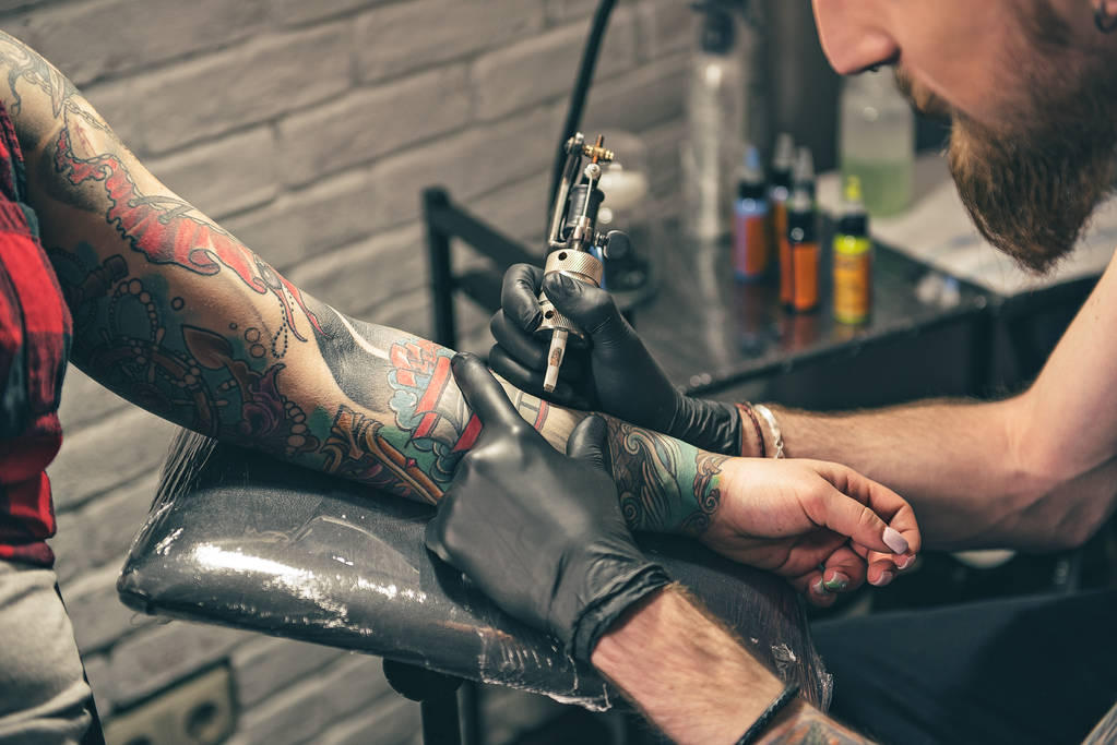 Γαλήνια γενειοφόρος άνδρας, δημιουργώντας τατουάζ στο χέρι - Φωτογραφία, εικόνα