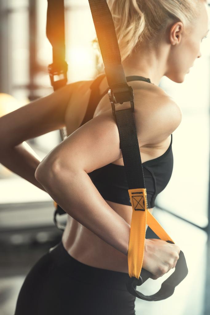 Blonde Fitness-Frau trainiert mit trx Fitnessbändern - Foto, Bild