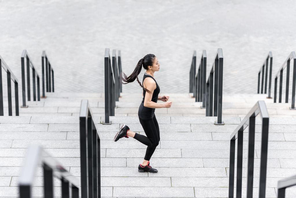 Sportswoman training on stadium stairs  - Photo, Image